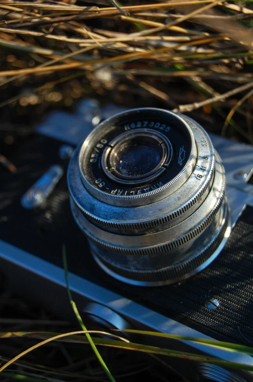 a camera sitting on top of a wooden table, by Sven Erixson, film artifacts, winter sun, metal eye piece, medium format