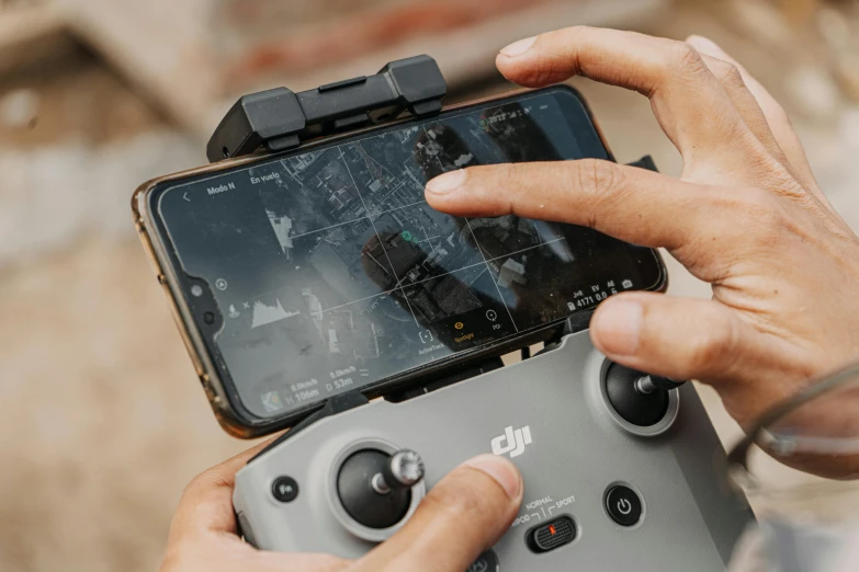 a close up of a person holding a game controller, happening, dji top down view, phone!! held up to visor, focus on map, thumbnail