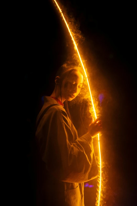 a man holding a lit up surfboard in the dark, by Adam Marczyński, light and space, fire staff, she is holding a long staff, avatar image, close - up photo