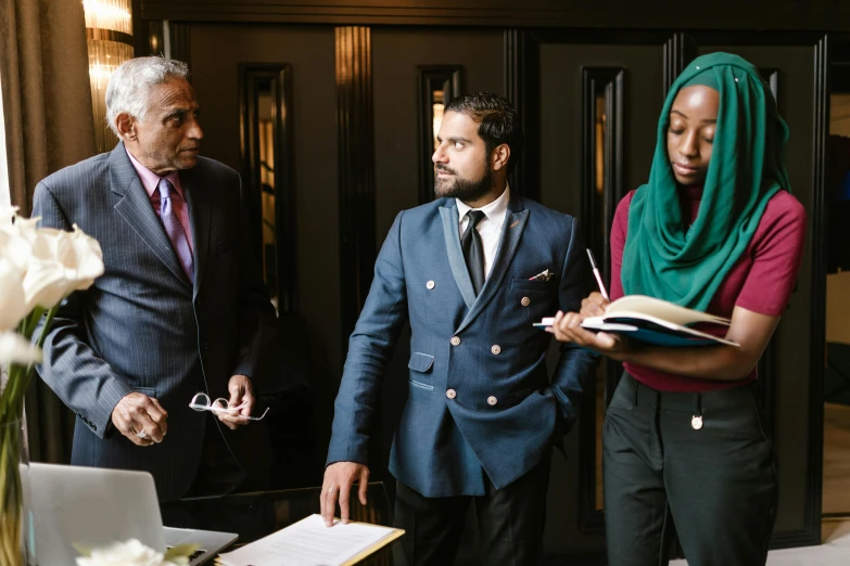 a group of people standing next to each other, pexels contest winner, hurufiyya, three piece suit, in meeting together, rich colour, academic clothing