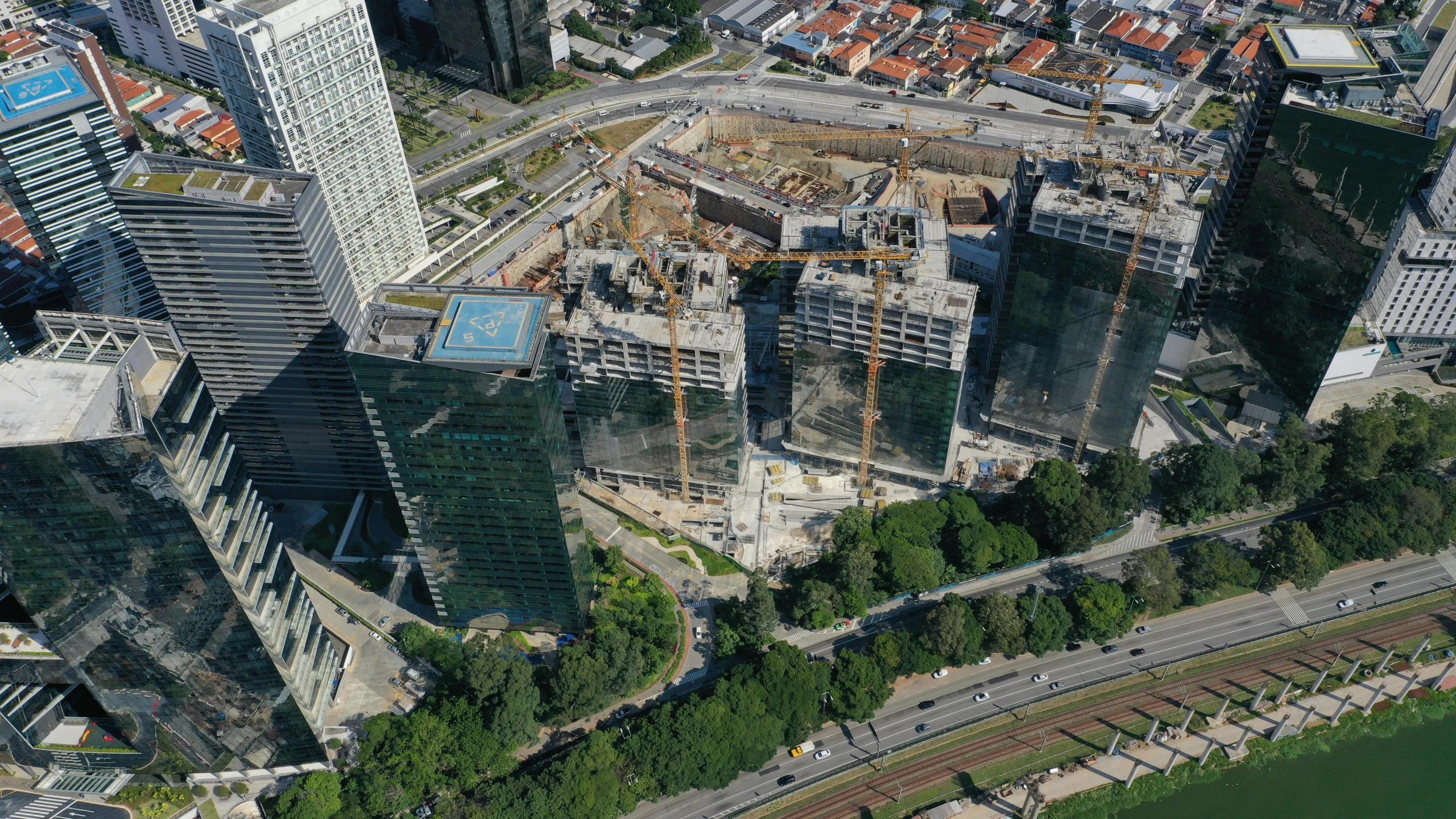 an aerial view of a city with lots of tall buildings, by Felipe Seade, reddit, photorealism, construction site, avatar image, singapore, santiago calatrava