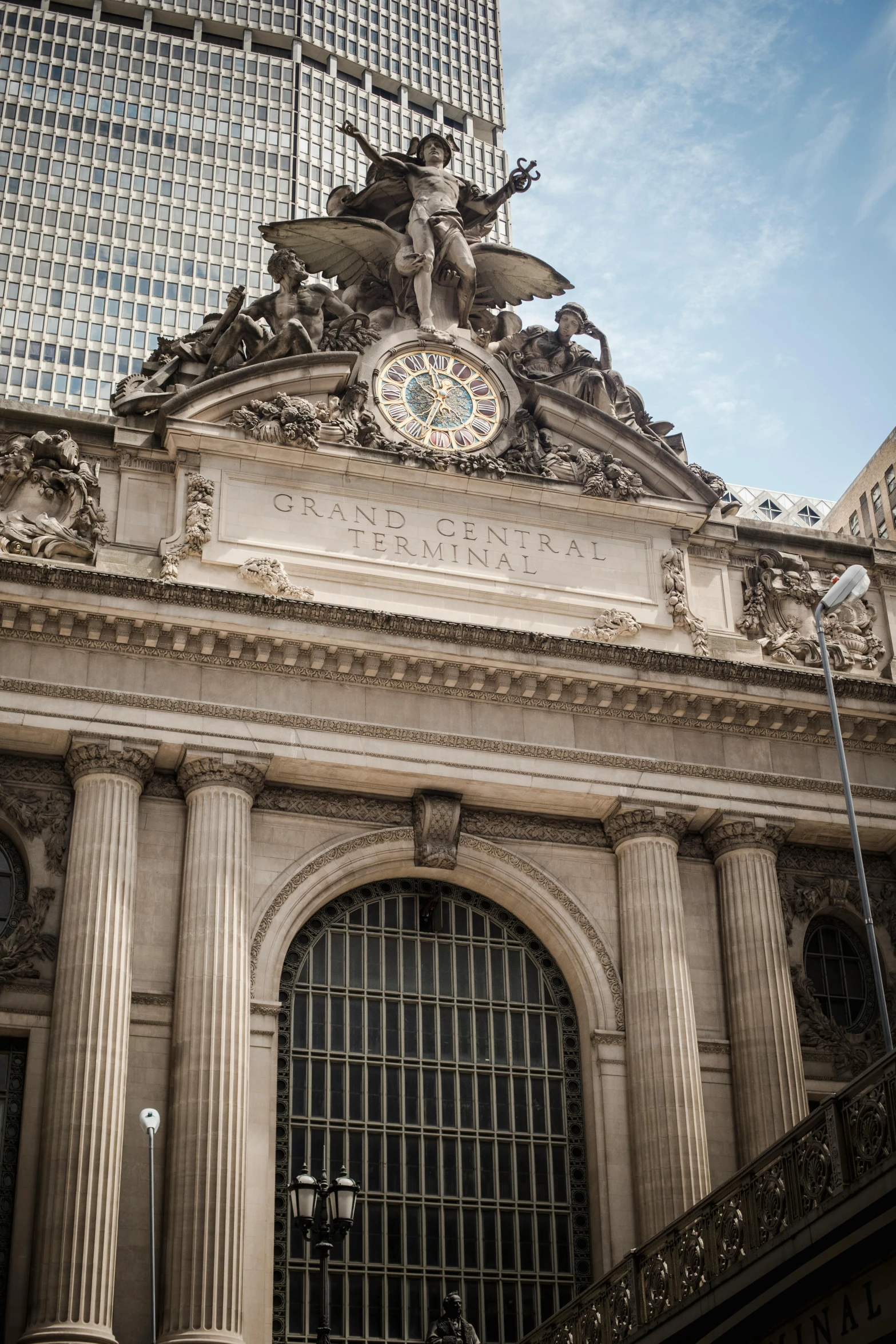 a large building with a clock on top of it, giant majestic archways, manhattan, intricate ”