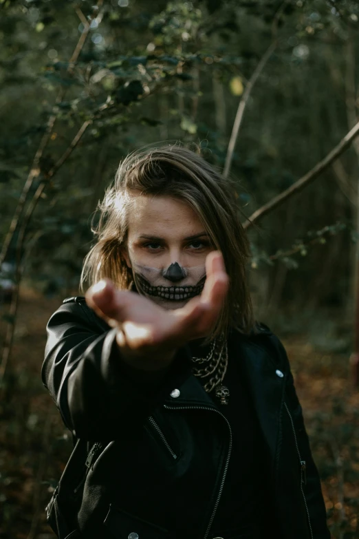 a girl wearing a bandana in the woods, an album cover, inspired by Elsa Bleda, pexels contest winner, graffiti, skulls in hands, wearing leather jacket, minimal black skull warpaint, headshot profile picture