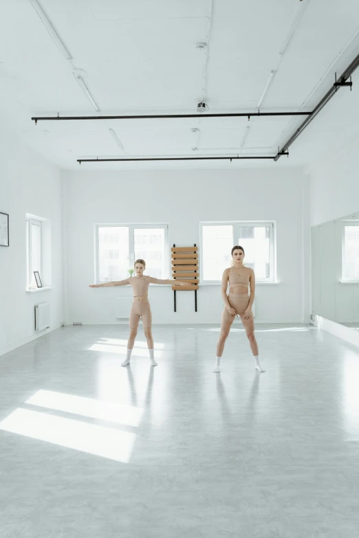 a couple of people that are standing in a room, inspired by Vanessa Beecroft, unsplash, conceptual art, dancer, фото девушка курит, slightly sunny, adult pair of twins