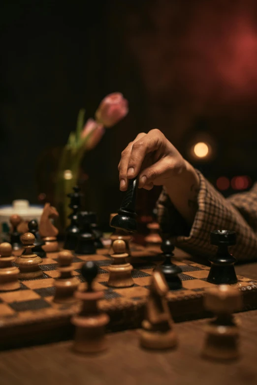 a person playing a game of chess on a table, by Jesper Knudsen, unsplash contest winner, renaissance, 15081959 21121991 01012000 4k, flowers around, 8k cinematic, portrait mode photo