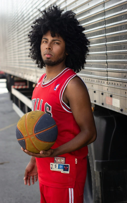 a man standing in front of a truck holding a basketball, an album cover, pexels, long afro hair, headshot profile picture, 15081959 21121991 01012000 4k, red horns