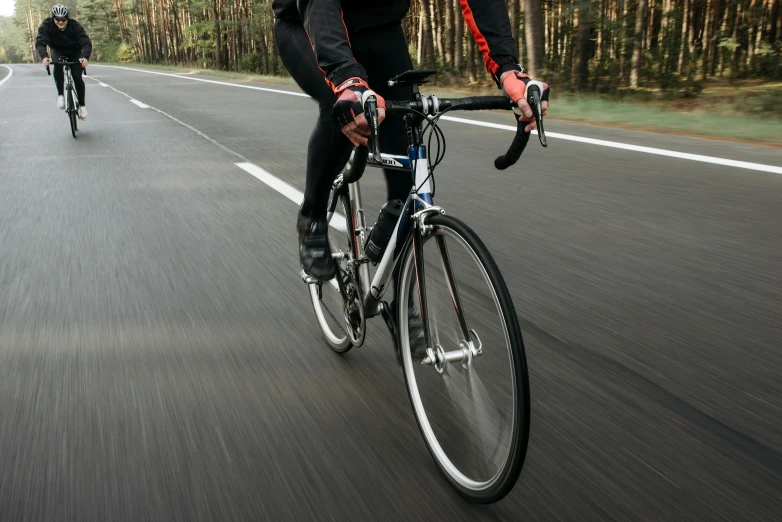 a couple of people riding bikes down a road, pexels contest winner, realism, sport clothing, black, instrument, rectangle