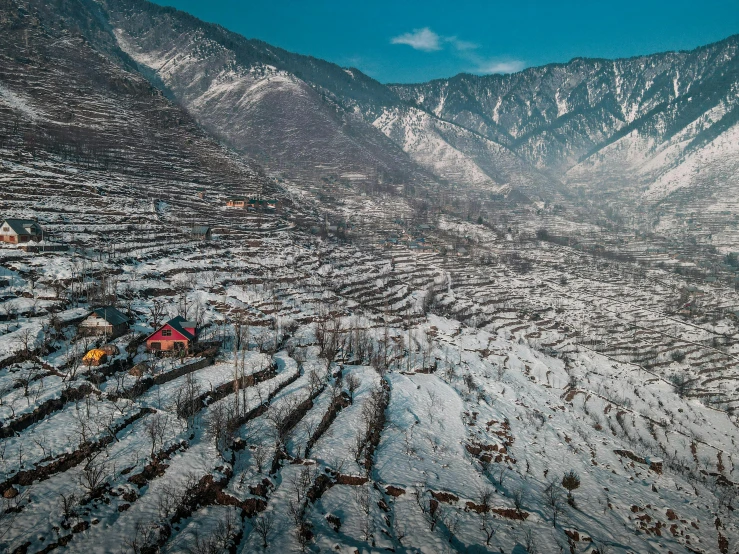 a group of tents sitting on top of a snow covered hillside, by Simon Gaon, pexels contest winner, baroque, terraced orchards and ponds, uttarakhand, drone photograpghy, wide view of a farm