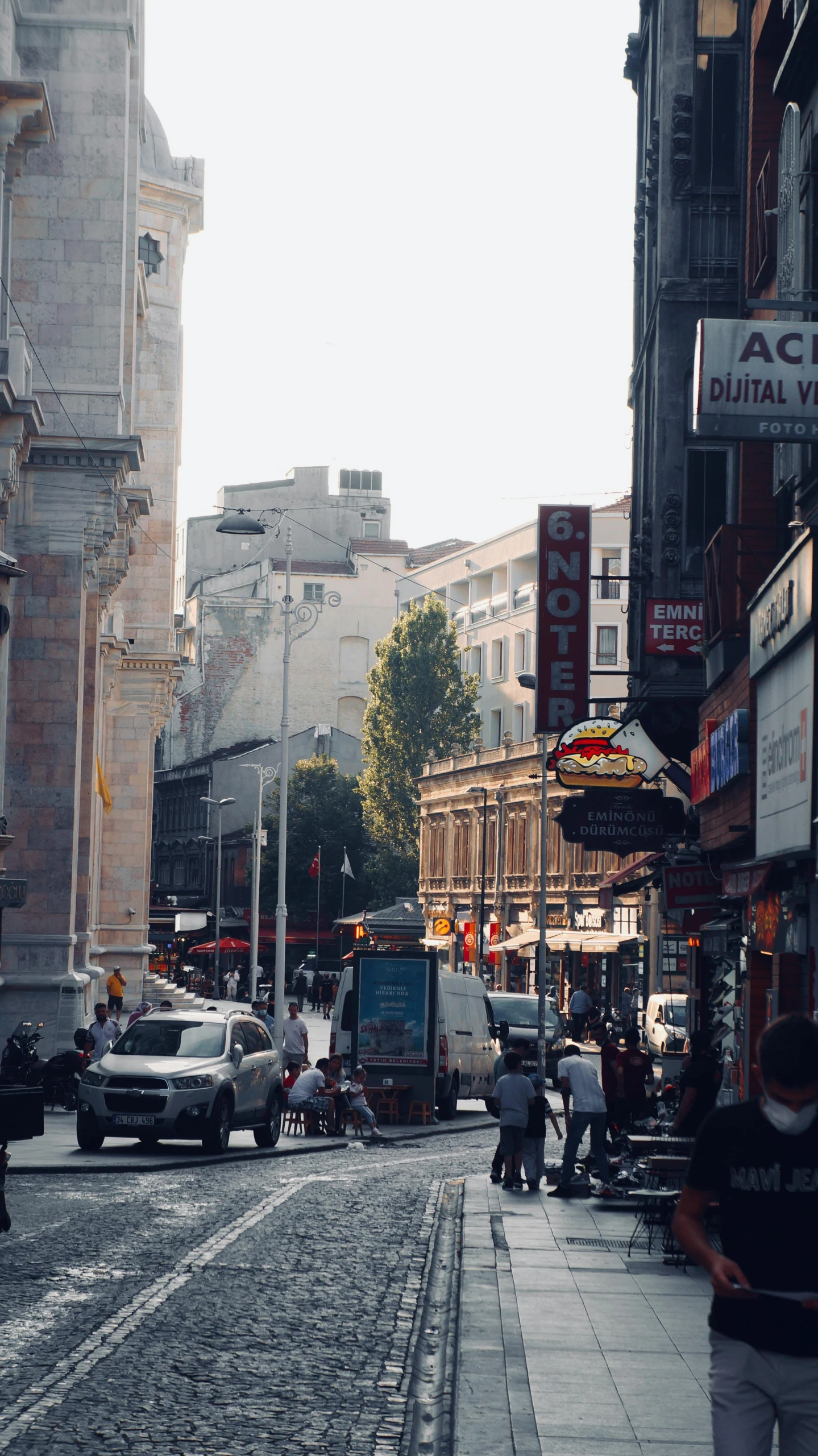 a group of people walking down a street next to tall buildings, istanbul, chinatown, medium, square