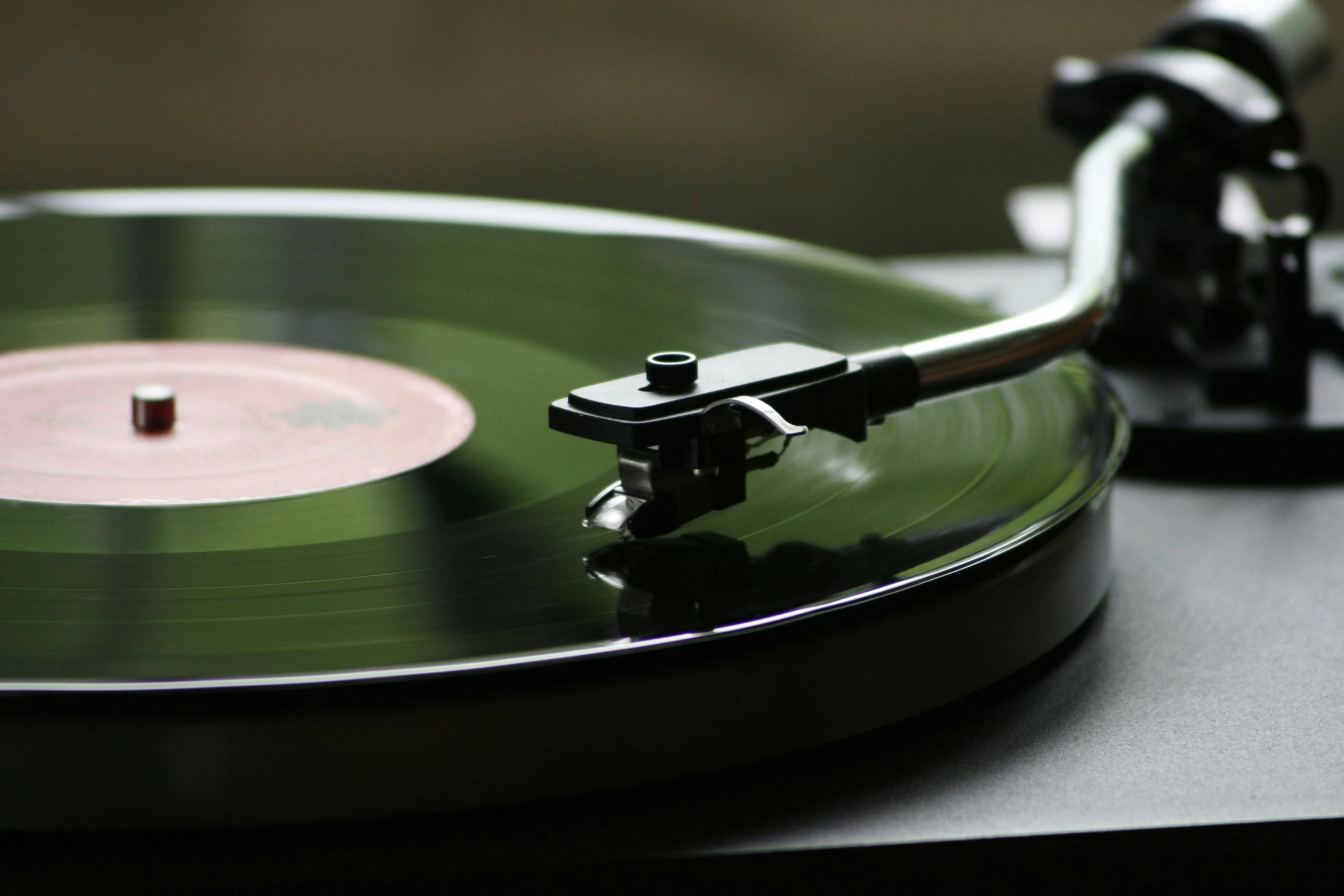 a close up of a record player's turntable, an album cover, unsplash, private press, paul barson, delightful surroundings, black matte finish, action shot