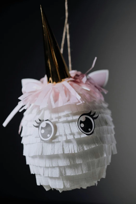 a unicorn pinata hanging from a string, inspired by Maki Haku, under light, face shown, frill, innovative