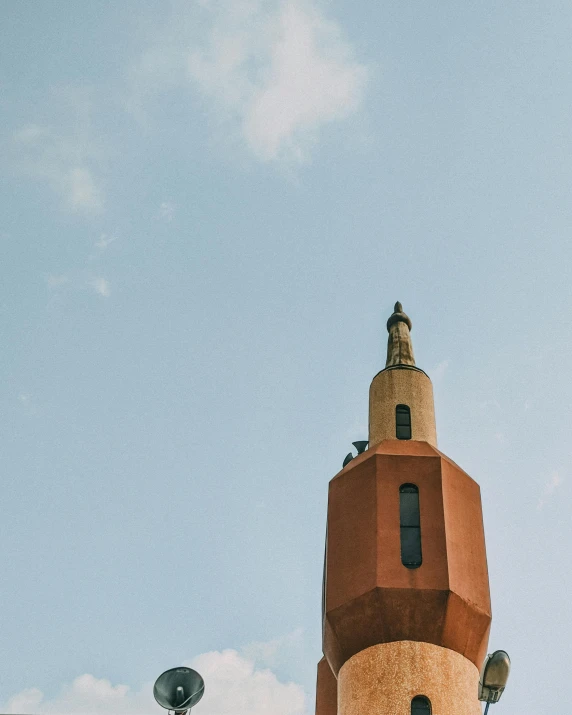 a tall tower with a clock on top of it, by Jacob Burck, unsplash contest winner, brutalism, moroccan mosque, terracotta, in barcelona, seaview