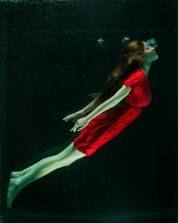 a woman in a red dress swimming under water, in its dying breath, 5 0 0 px, featured art