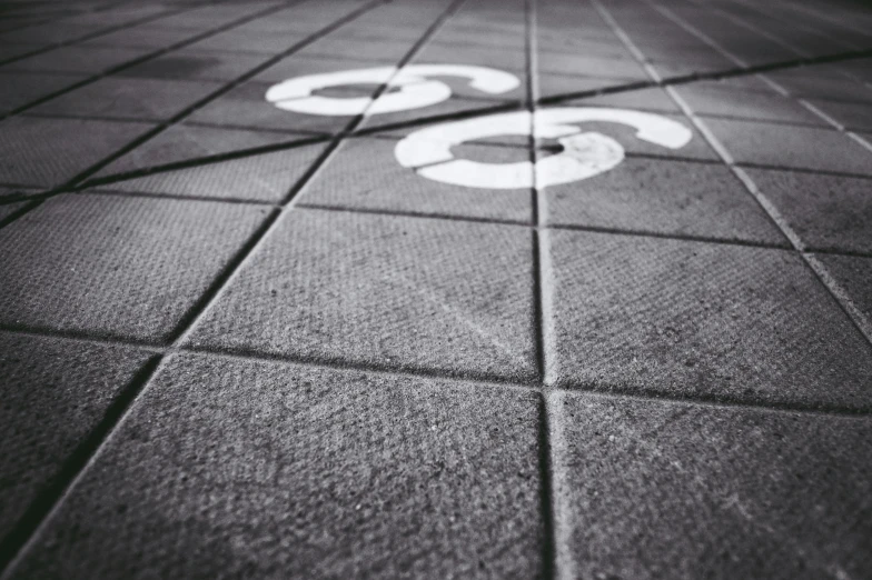 a black and white photo of a street sign, a black and white photo, unsplash, graffiti, floor tiles, triple six, circles, high res 8k