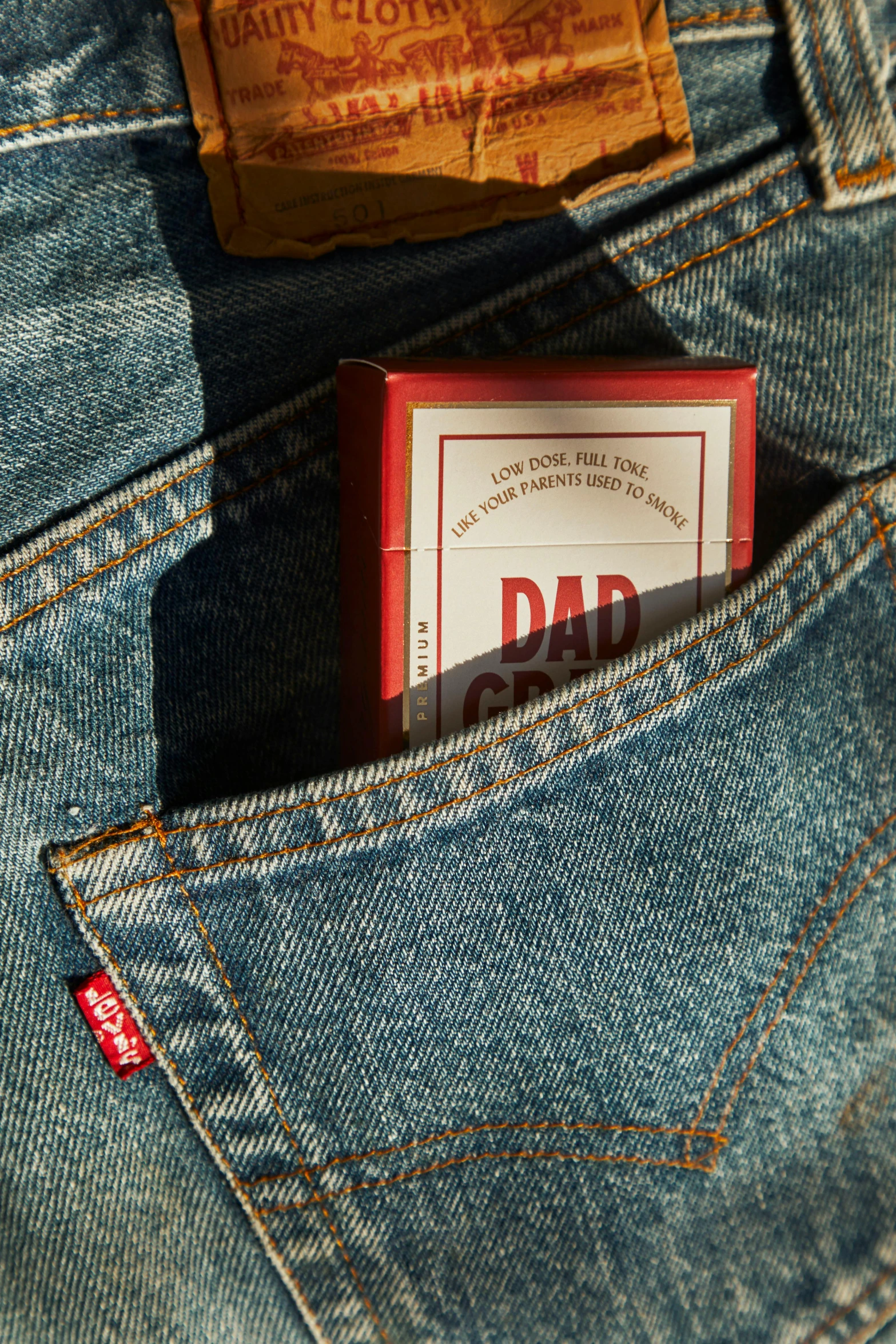 a cigarette in the back pocket of a pair of jeans, an album cover, by Paul Bird, unsplash, dada, card game, i'm dad, shit grows, 6 : 3 0 am