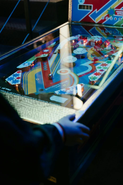 a close up of a person playing a pinball game, by Matthias Stom, unsplash, interactive art, paul barson, square, taken in the late 2010s, arcade cabinet