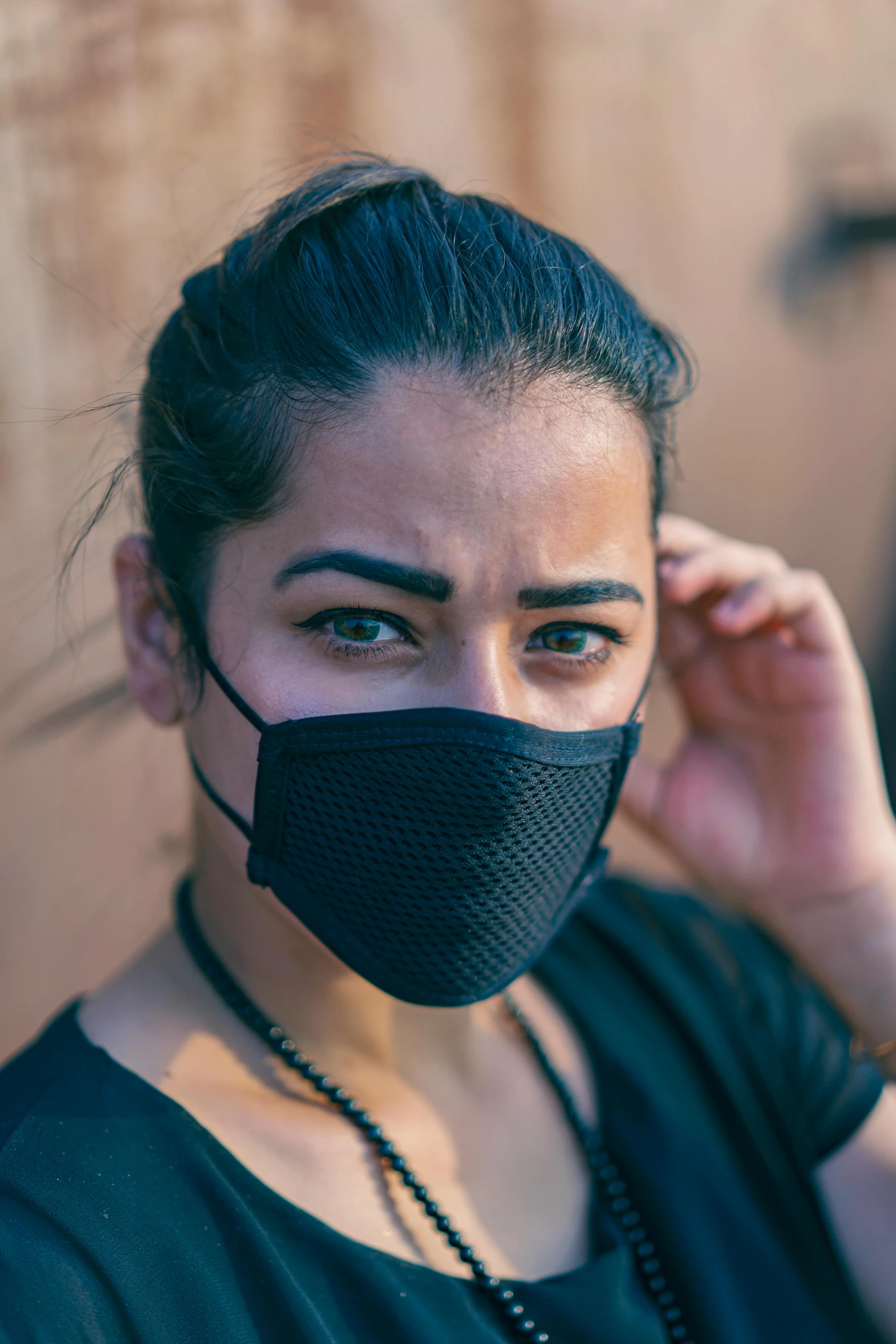a woman wearing a black face mask, hardmesh, environmental shot, concerned, uncrop