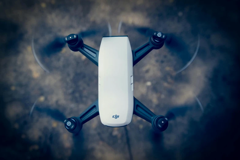 a small white drone flying through the air, unsplash, hurufiyya, on ground, videogame still, frontal shot, 2 0 0 0's photo