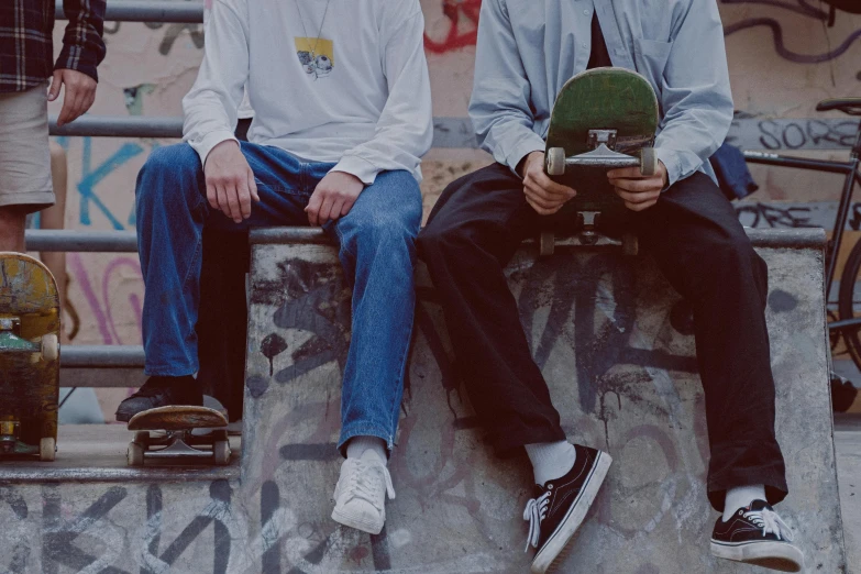 a couple of men sitting on top of a skateboard ramp, unsplash, realism, white shirt and jeans, banner, low quality photo, 15081959 21121991 01012000 4k