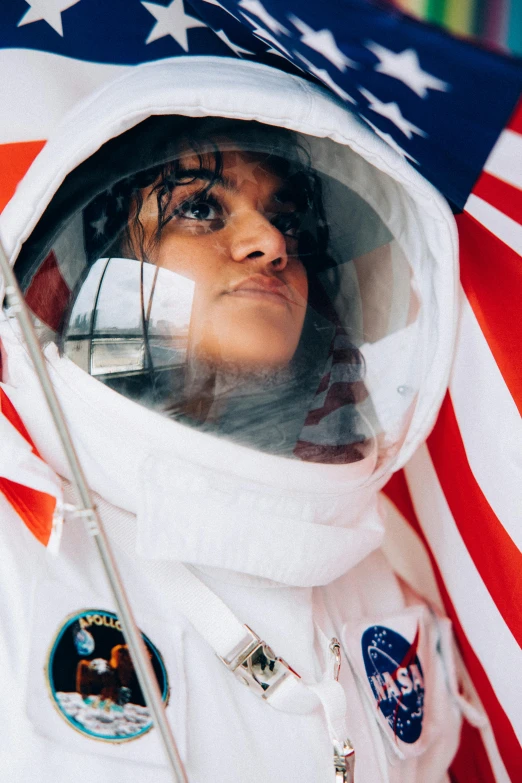 a woman in an astronaut suit holding an american flag, trending on unsplash, renaissance, portrait of priyanka chopra, ☁🌪🌙👩🏾, looking away from camera, 6