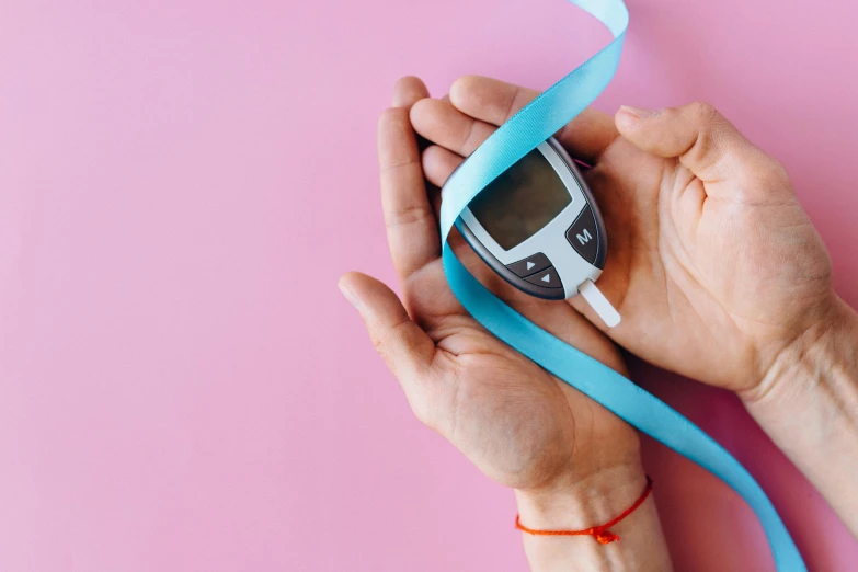 a close up of a person holding a cell phone, ribbon, blue and pink, holding scale and holding sword, digital medical equipment