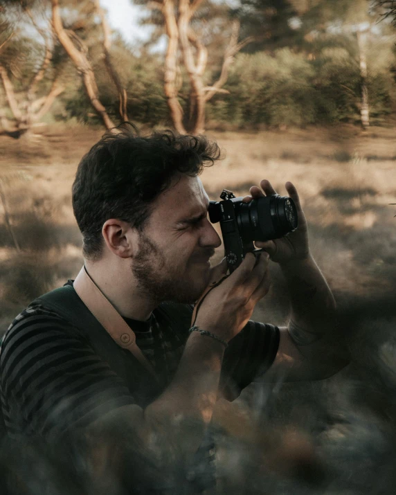 a man taking a picture of a giraffe in the wild, a picture, inspired by Steve McCurry, unsplash contest winner, australian tonalism, looking at camera!!!, portrait photography 4 k, petzval lens, **cinematic