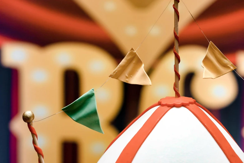 a circus tent with flags hanging from it, inspired by The Family Circus, trending on pexels, magic realism, miniature cafe diorama, inflateble shapes, brown, promotional image