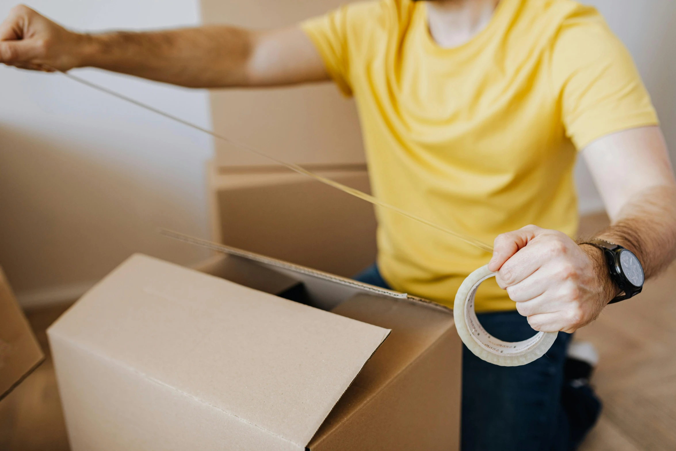 a man in a yellow shirt is holding a tape, by Lee Loughridge, pexels contest winner, hurufiyya, delivering parsel box, avatar image, furniture, sydney