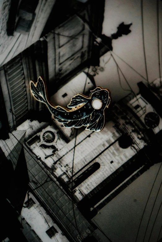 a fish hanging from the side of a building, inspired by Kanō Hōgai, unsplash, conceptual art, pins, flying over dark gotham, enamel, loish |