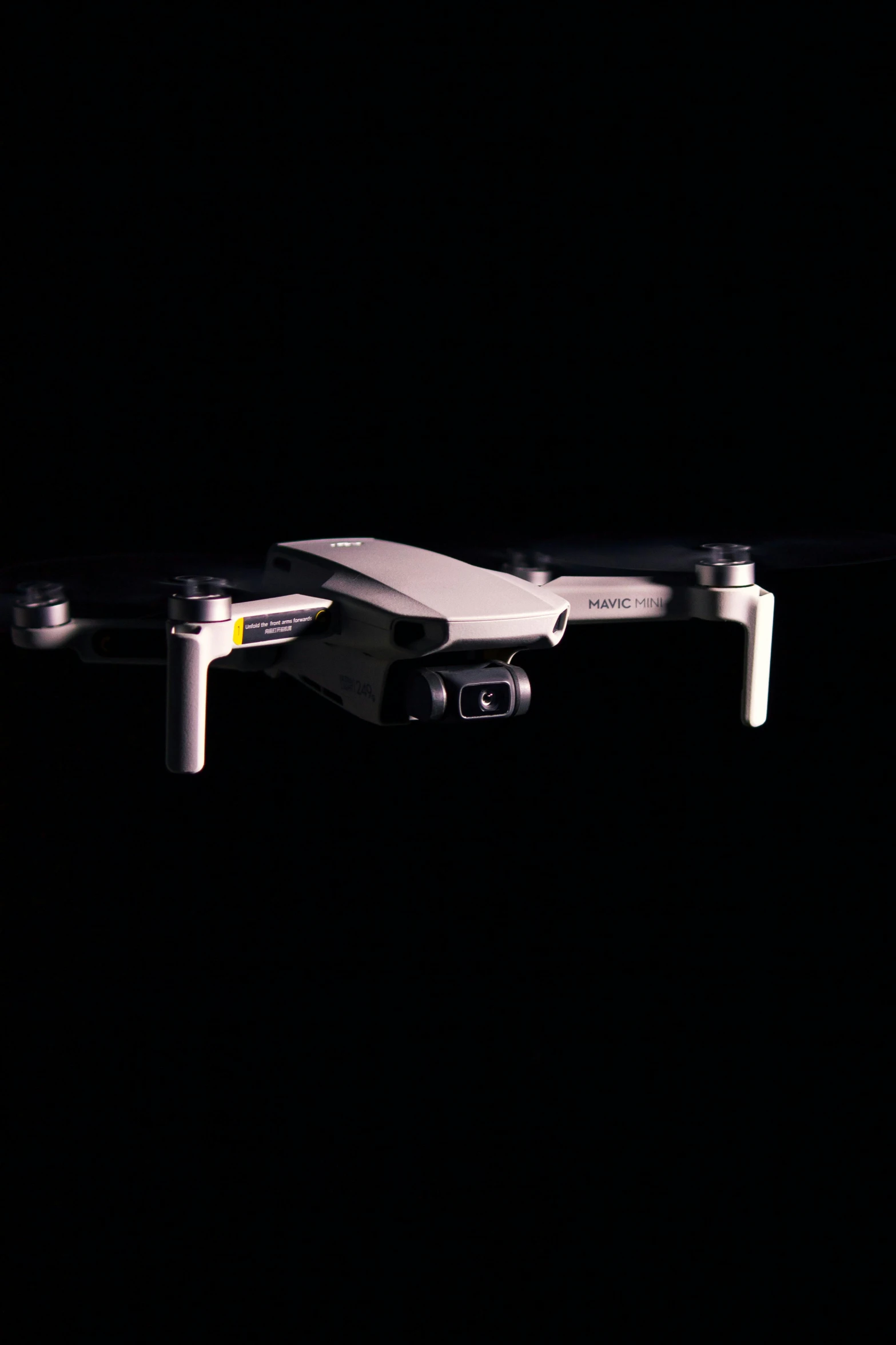 a small white drone flying in the dark, a digital rendering, unsplash, bauhaus, realistic footage, mini model, full frame image, taken on iphone 14 pro