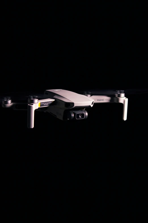 a small white drone flying in the dark, a digital rendering, unsplash, bauhaus, realistic footage, mini model, full frame image, taken on iphone 14 pro