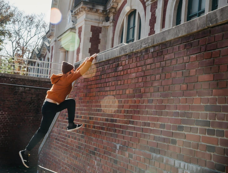 a man flying through the air while riding a skateboard, pexels contest winner, graffiti, hiding behind a brick wall, outside the'school of magic ', profile image, climbing