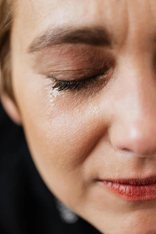 a close up of a woman with her eyes closed, crying one single tear, sweaty face, mourning, profile image