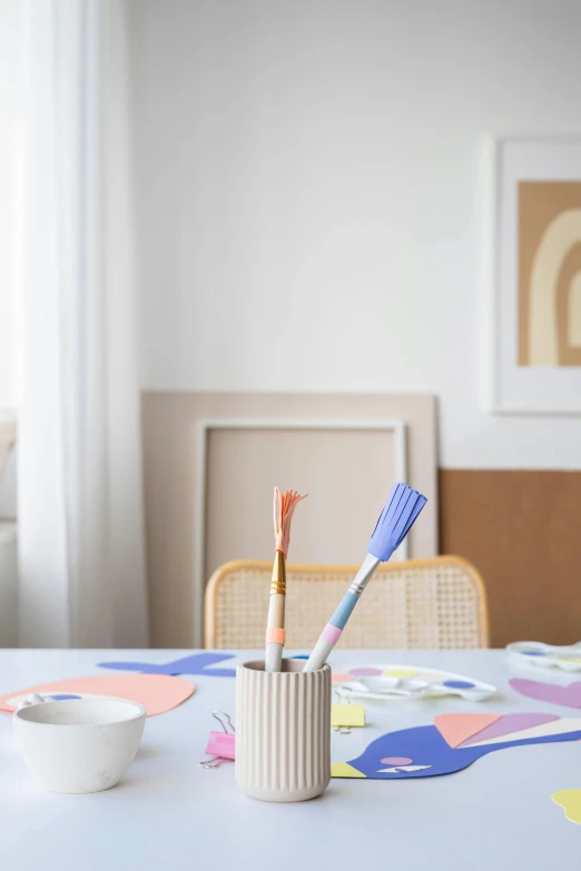 a toothbrush holder sitting on top of a table, a child's drawing, unsplash, process art, in pastel shades, dining table, studio junio color palette, game board