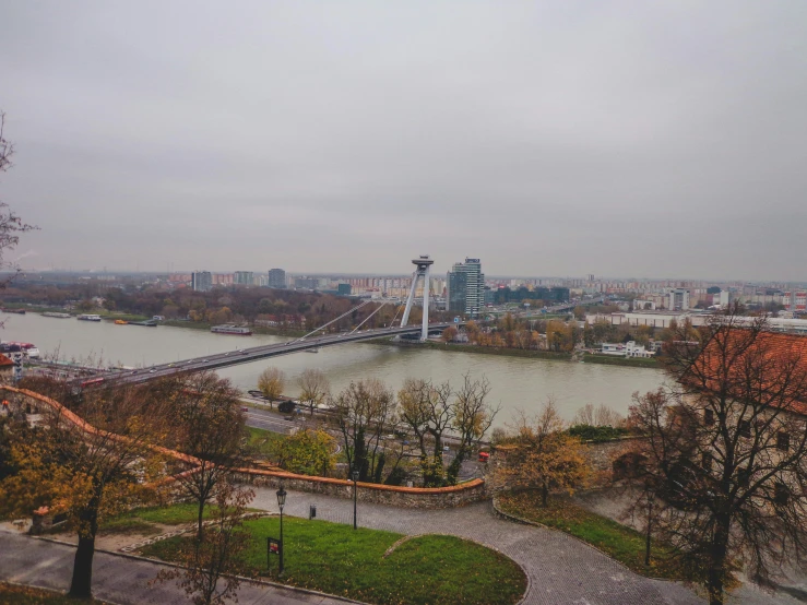 a view of a bridge over a body of water, by Emma Andijewska, pexels contest winner, happening, rostov city, panoramic view, autum, grey