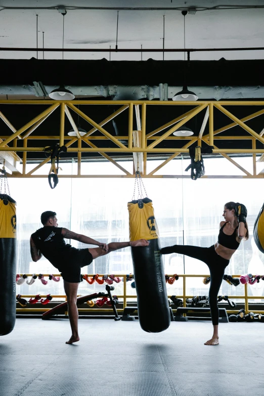 a group of people practicing kickboxing in a gym, by Robbie Trevino, happening, yellow lanterns, bangkok, wētā fx, beautiful views