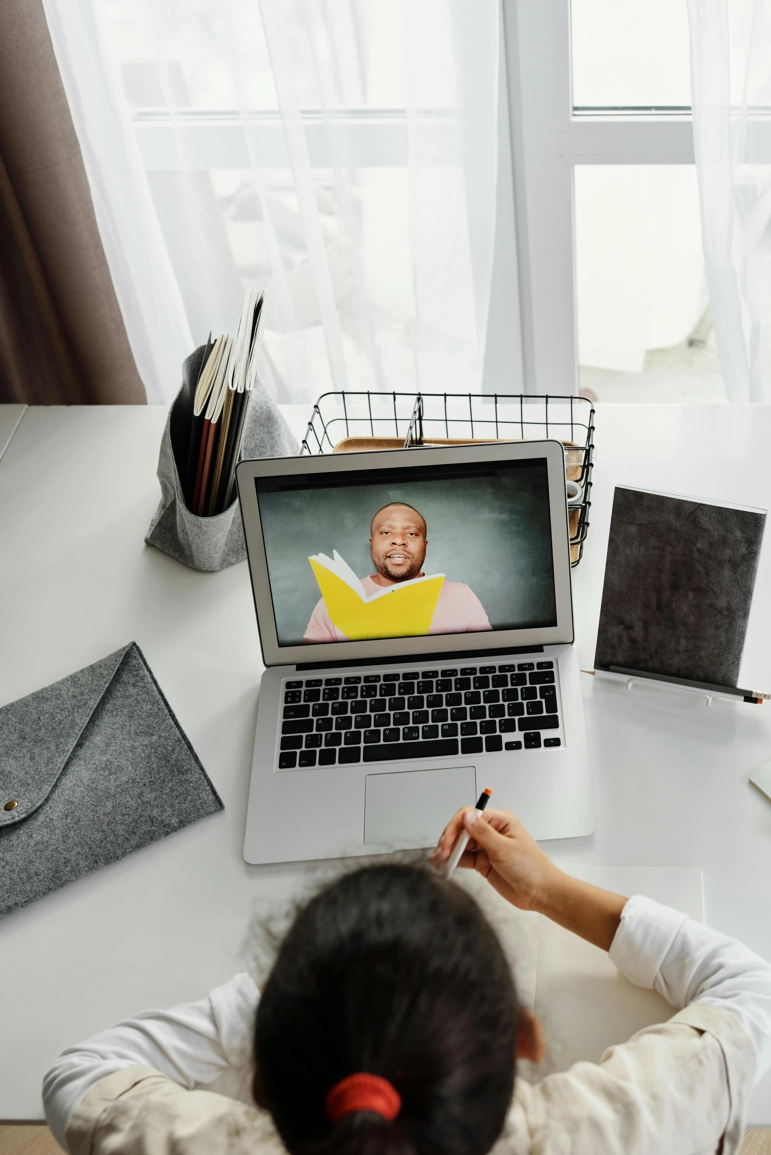 a woman sitting at a desk in front of a laptop computer, trending on pexels, happening, teacher, photograph from above, still from a movie, avatar image