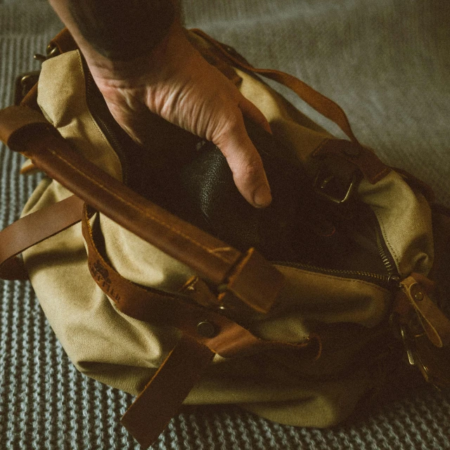 a close up of a person holding a bag, vintage muted colors, preparing to fight, instagram post, luggage