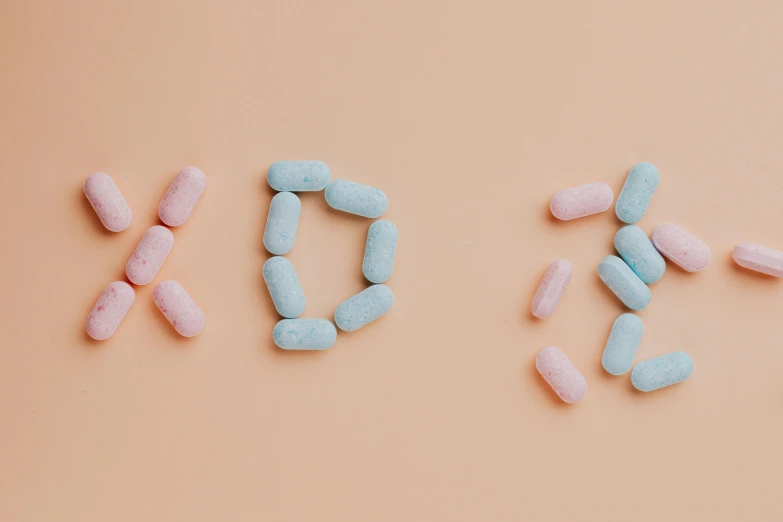 the word sex spelled out of pills on a pink background, trending on pexels, antipodeans, blue text that says 3kliksphilp, h. u. d, d&d vibe, jovana rikalo