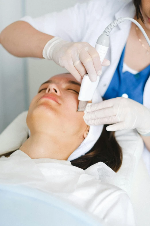 a woman getting a procedure on her face, a photo, happening, square, white, synthetic skin, thumbnail