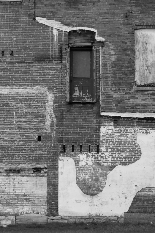 a black and white photo of an old building, inspired by Arnold Newman, conceptual art, hiding behind a brick wall, variety of shapes and textures, annie lebowitz, ( ( photograph ) )