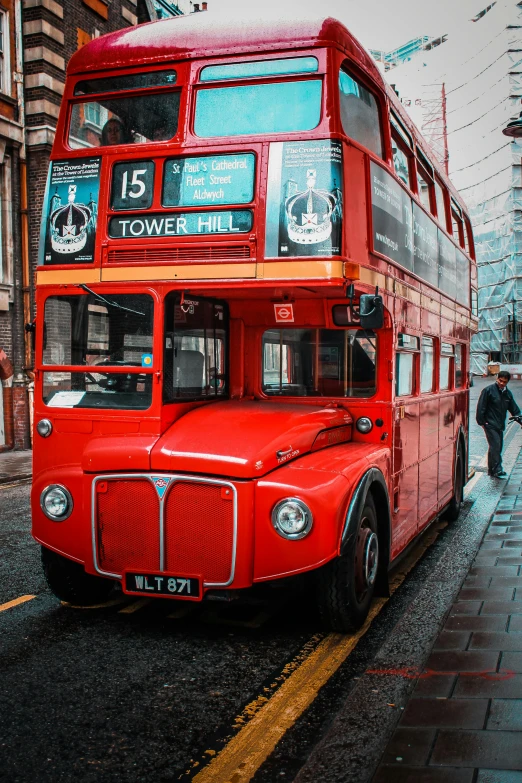 a red double decker bus driving down a street, by Matt Stewart, pexels contest winner, art nouveau, square, red boots, color splash, england