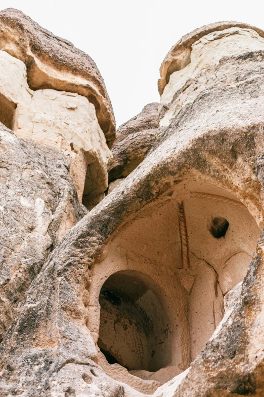 a couple of rocks that have holes in them, trending on pexels, art nouveau, turkey, dry archways and spires, white wall complex, ben ridgway