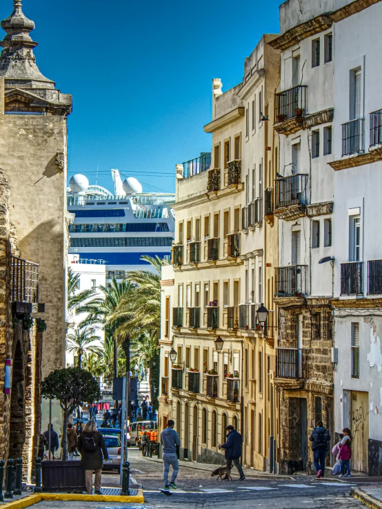 a narrow street with a cruise ship in the background, moorish architecture, golden cityscape, high-quality photo, high quality image”