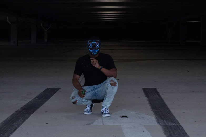 a man sitting on a skateboard in a parking garage, an album cover, pexels contest winner, graffiti, blue lens airsoft mask, ( ( dark skin ) ), vantablack chiaroscuro, black bandana mask
