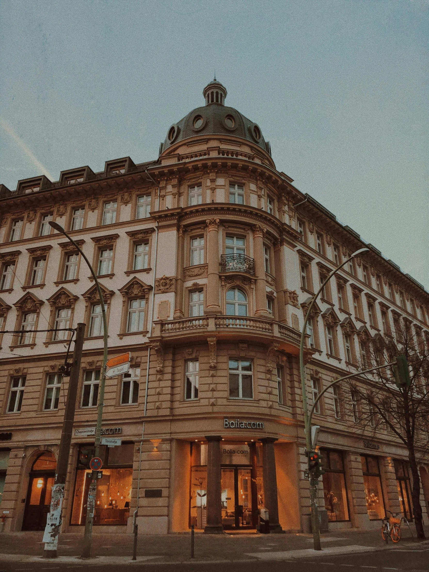 a tall building sitting on the side of a street, by Emma Andijewska, pexels contest winner, art nouveau, 🎀 🧟 🍓 🧚, warm glow, brown, store