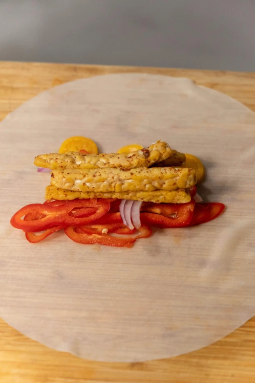 a close up of a plate of food on a table, wrapped thermal background, yellow charcoal, weenie, on parchment