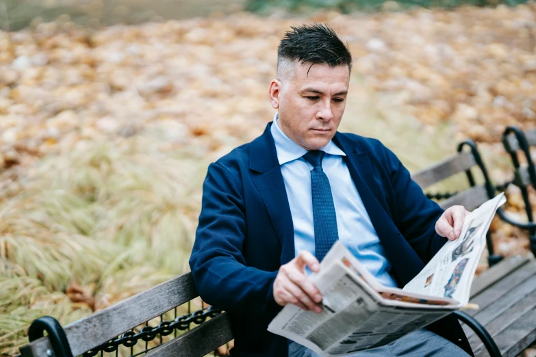 a man sitting on a bench reading a newspaper, a portrait, unsplash, wearing a pinstripe suit, avatar image, julian ope, outdoor photo