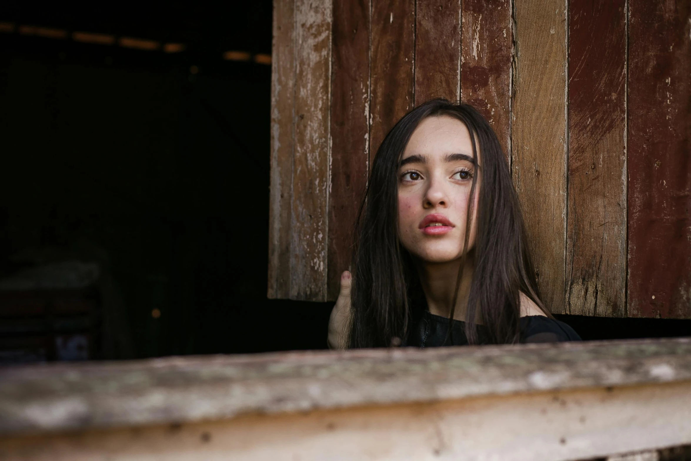 a close up of a person looking out of a window, by Winona Nelson, pexels contest winner, realism, dilraba dilmurat, in an abandoned barn, lilly collins, square