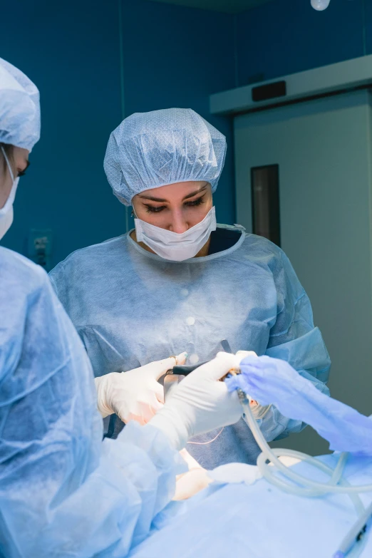 a group of surgeons working on a patient, a picture, by Adam Marczyński, shutterstock, multiple stories, female, 2995599206